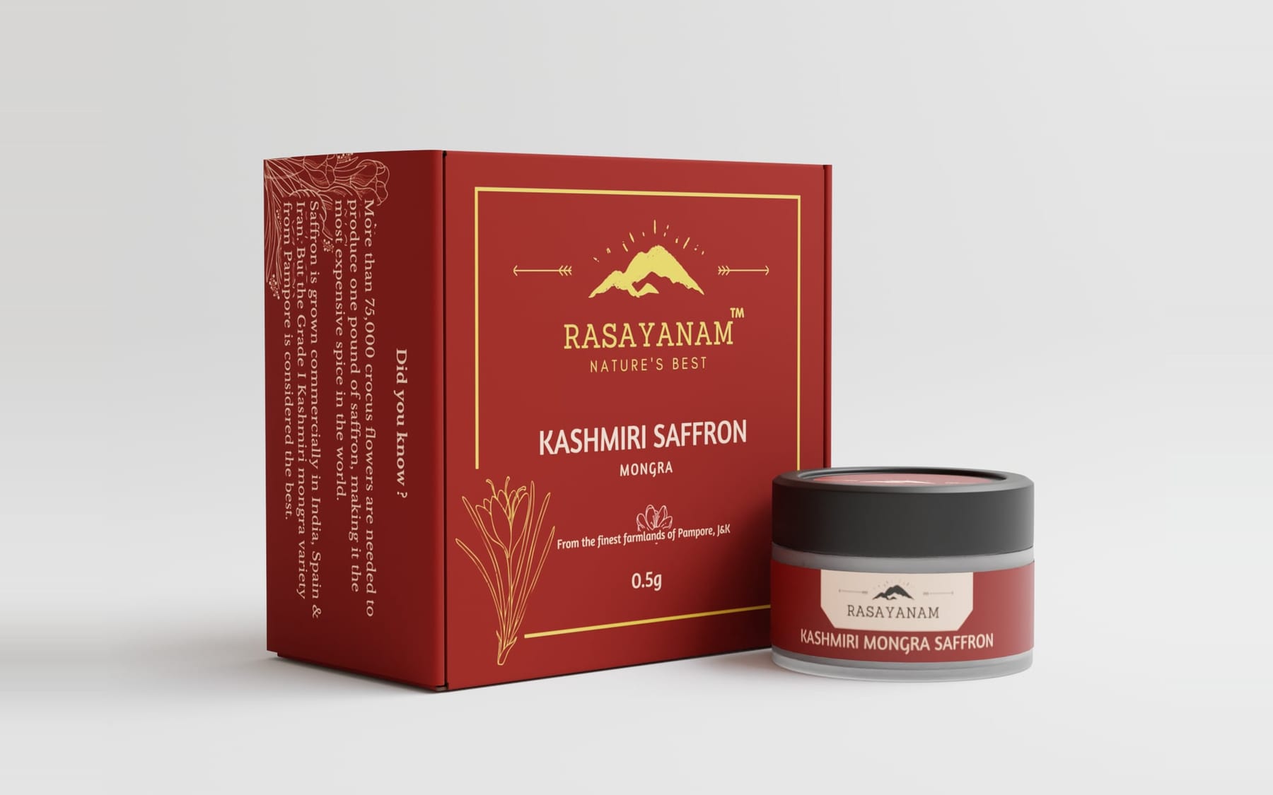 A 3D render of the Kashmiri Saffron 0.5g packaging: a red box with a gold border, the Rasayanam mountain logo and a saffron-flower line drawing, beside a small jar with a red label.